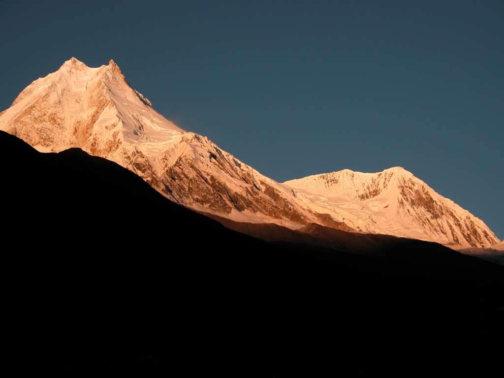 Manaslu 07 04 Manaslu and Manaslu North Sunrise From Syala Manaslu became very much a Japanese mountaineering property in the 1950s, and was climbed in May 1956 by Toshio Imanishi and Gyalzen Norbu Sherpa, members of an expedition led by Yuko Maki, who set their base camp above Sama beside the Manaslu Glacier. Manaslu North (7157m) was first climbed on October 25, 1964 by Fons Driessen and Jan De Lint from Holland, Hubert Schriebl from Austria, and Sherpas Jila Tsering and Nima Tenzing.